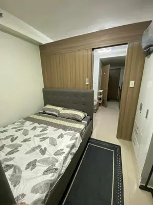 a bedroom with a bed in a room at Shore Residences in Manila
