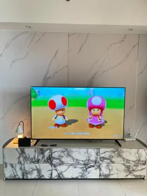 a television with two mario characters on the screen at Venetian Haven BGC Venice Grand Canal Apart ment, 4 Bedrooms, for 10 Guests in Manila