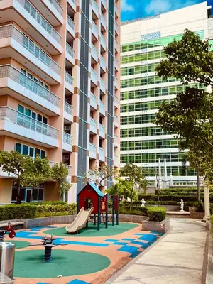 a playground in front of a tall building at Venetian Haven BGC Venice Grand Canal Apart ment, 4 Bedrooms, for 10 Guests in Manila