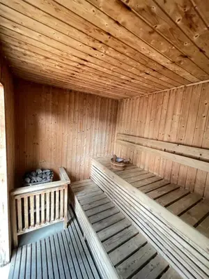an empty wooden sauna with wooden floors and ceilings at Venetian Haven BGC Venice Grand Canal Apart ment, 4 Bedrooms, for 10 Guests in Manila