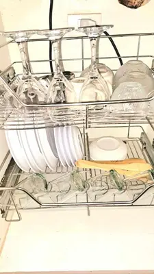 a shelf in a dishwasher with dishes and wine glasses at Searendipity - Sea Residences, Pasay City in Manila