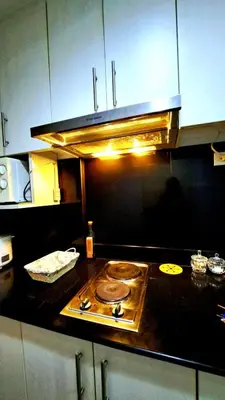 a kitchen with a counter top with a stove at Searendipity - Sea Residences, Pasay City in Manila