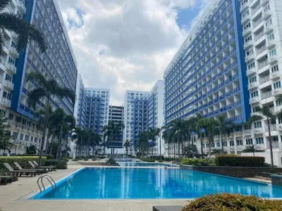 a large swimming pool in a city with tall buildings at Searendipity - Sea Residences, Pasay City in Manila