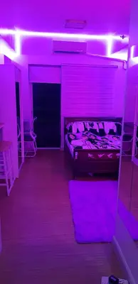 a purple room with a bed and a purple lighting at House of Bangtan at Grace Residences, Taguig in Manila