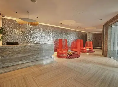 a waiting room with red chairs and a wall at Rockwell View Twin Suite with FREE WiFi Pool & Gym in Manila
