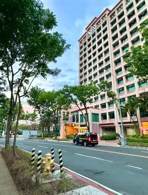 a car driving down a street next to a large building at Studio Two Condominium - Alabang, BLK - Northgate Cyberzone, Filinvest City, Alabang - Netflix-ready Fiber Wi-Fi in Manila