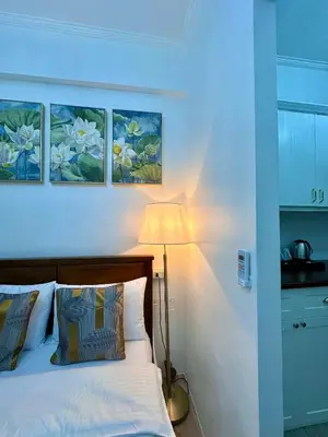 a bedroom with a bed with three paintings on the wall at Studio Two Condominium - Alabang, BLK - Northgate Cyberzone, Filinvest City, Alabang - Netflix-ready Fiber Wi-Fi in Manila