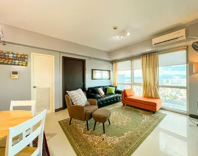 a living room with a couch and a table at Le Grand one in Manila