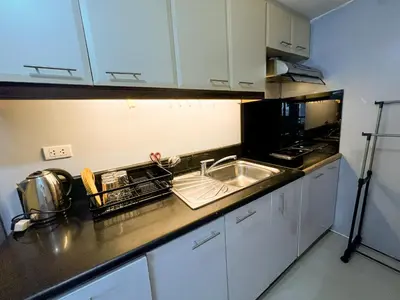 a kitchen with a sink and a microwave at Le Grand one in Manila