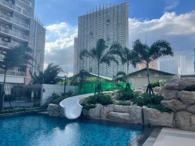 a swimming pool with a bath tub in a city at Vincondotel Near BGC Fairlane in Manila