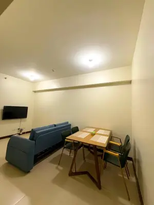 a living room with a couch and a table at Vincondotel Near BGC Fairlane in Manila
