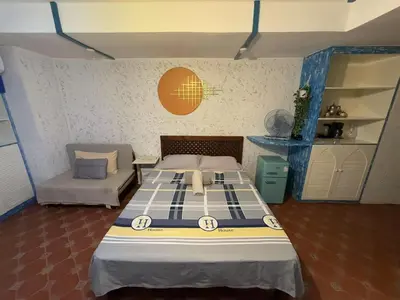 a bedroom with a bed and a couch and a bed at Vincondotel Roxas Ave Manila 1BR Marbella in Manila