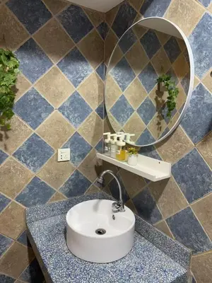 a bathroom with a sink and a mirror at Vincondotel Roxas Ave Manila 1BR Marbella in Manila