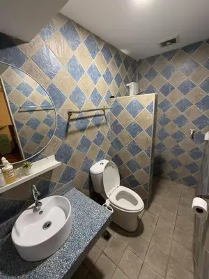a bathroom with a toilet and a sink at Vincondotel Roxas Ave Manila 1BR Marbella in Manila