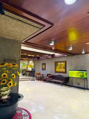 a large room with a television and tables and chairs at Vincondotel Roxas Ave Manila 1BR Marbella in Manila