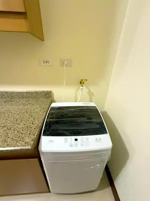 a toaster oven sitting in a kitchen next to a counter at Vincondotel Near BGC 2BR Fairlane in Manila