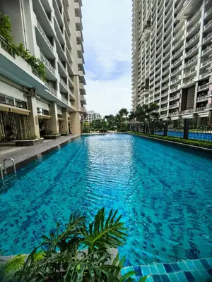 a swimming pool in the middle of two buildings at Fairlane Residences in Manila