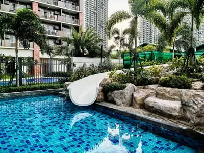 a slide in a swimming pool in a resort at Fairlane Residences in Manila