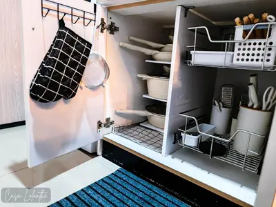 a cupboard filled with lots of kitchen utensils at Casa Lolanthe Fully Furnished Studio Unit in Pasong Bayog