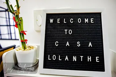 a sign that says welcome to caesarle london with a plant at Casa Lolanthe Fully Furnished Studio Unit in Pasong Bayog