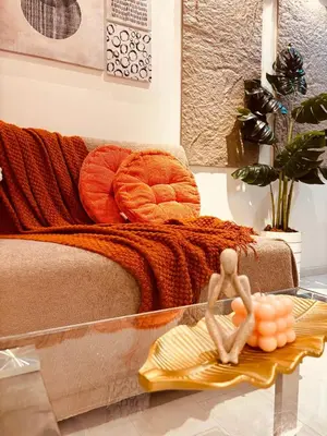 a glass table with two figurines on top of a bed at Azure Beach Comfy Cozy Suite in Manila