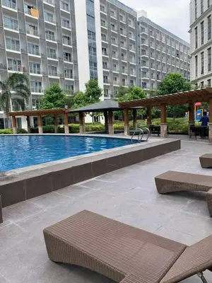 a swimming pool in a building with benches and buildings at 81 Newport Blvd Cluster 4 Unit 10C by Rechelle Nunag in Manila