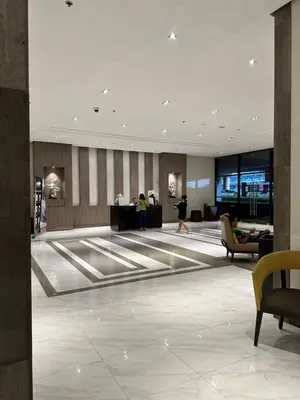 a lobby with people walking around in a building at 81 Newport Blvd Cluster 4 Unit 10C by Rechelle Nunag in Manila