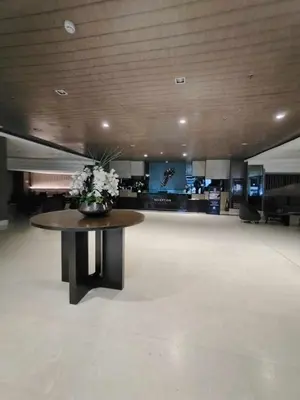 a lobby with a table with flowers on it at Pasay Shore Residences with one bedroom with balcony in Manila