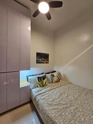 a bedroom with a bed and a ceiling fan at Best Place For You - Mall of Asia & Airport in Manila