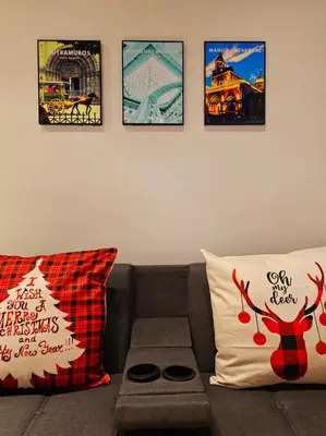 a living room with a couch and some pictures on the wall at Best Place For You - Mall of Asia & Airport in Manila