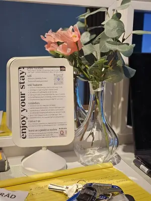 a vase with a flower in it next to a monitor at Best Place For You - Mall of Asia & Airport in Manila