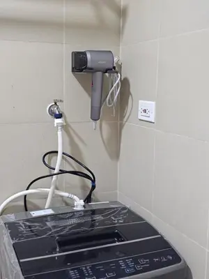 a phone on a wall next to a stove at Best Place For You - Mall of Asia & Airport in Manila