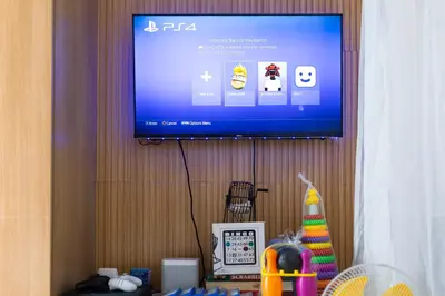 a flat screen tv hanging on a wall at 1Bedroom Beach View with Netflix near Airport in Manila