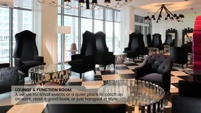 a salon with black chairs and tables and windows at 1Bedroom Beach View with Netflix near Airport in Manila