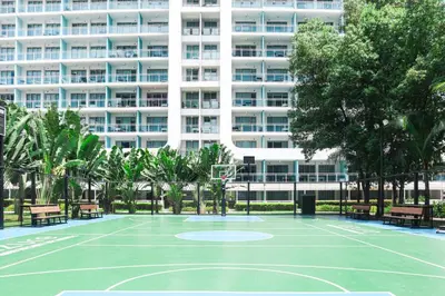 a basketball court in front of a building at 1Bedroom Beach View with Netflix near Airport in Manila
