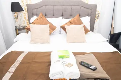 a bedroom with a bed with a remote control on it at 1Bedroom Beach View with Netflix near Airport in Manila