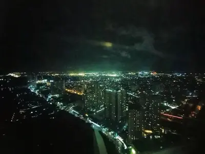 a view of a city at night with lights at Sonia Suite at The Beacon Makati in Manila