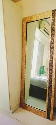 a mirror with a wooden frame on a wall at Azure Urban Residences By Lyn 2BR in Manila