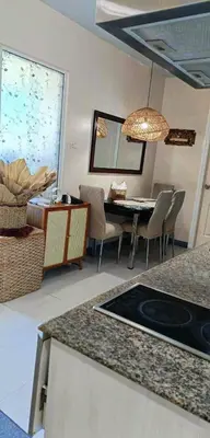 a kitchen and dining room with a table and chairs at Azure Urban Residences By Lyn 2BR in Manila