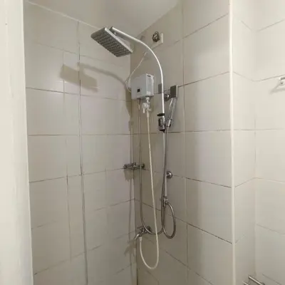 a shower with a shower head in a bathroom at Budget Family Group Room for 4 persons in Manila