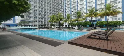 a large swimming pool in a building with palm trees at Budget Family Group Room for 4 persons in Manila