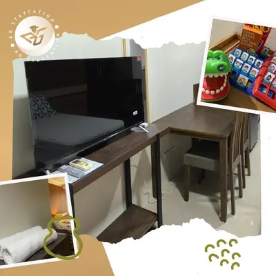 a room with a desk with a television and a chair at Deluxe Room with Balcony near MOA in Manila