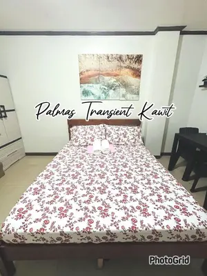 a bedroom with a bed with a red and white blanket at Palmas Transient Kawit in Kawit