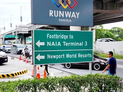 a sign for the newport world resorts at Casa Antonio at 7i Two Palm Tree Villas Beside NAIA3 in Manila