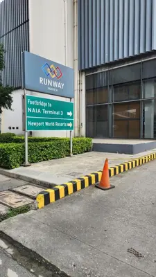 a yellow and black curb in front of a building at Casa Antonio at 7i Two Palm Tree Villas Beside NAIA3 in Manila