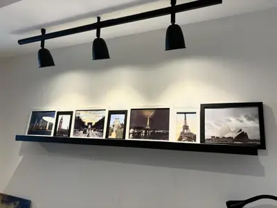 a shelf on a wall with pictures on it at Azure 2Br 1Ba with City View Balcony and Free Parking in Manila