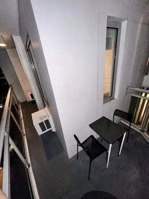 a room with a table and chairs in a building at Azure 2Br 1Ba with City View Balcony and Free Parking in Manila