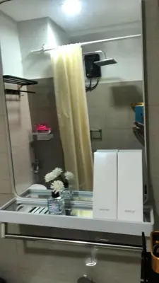 a bathroom mirror with a reflection of a shower at 3M Staycation in Manila