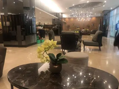 a lobby with a table with a potted plant on it at 3M Staycation in Manila