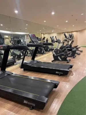 a gym with a bunch of treadmills in a room at 3M Staycation in Manila